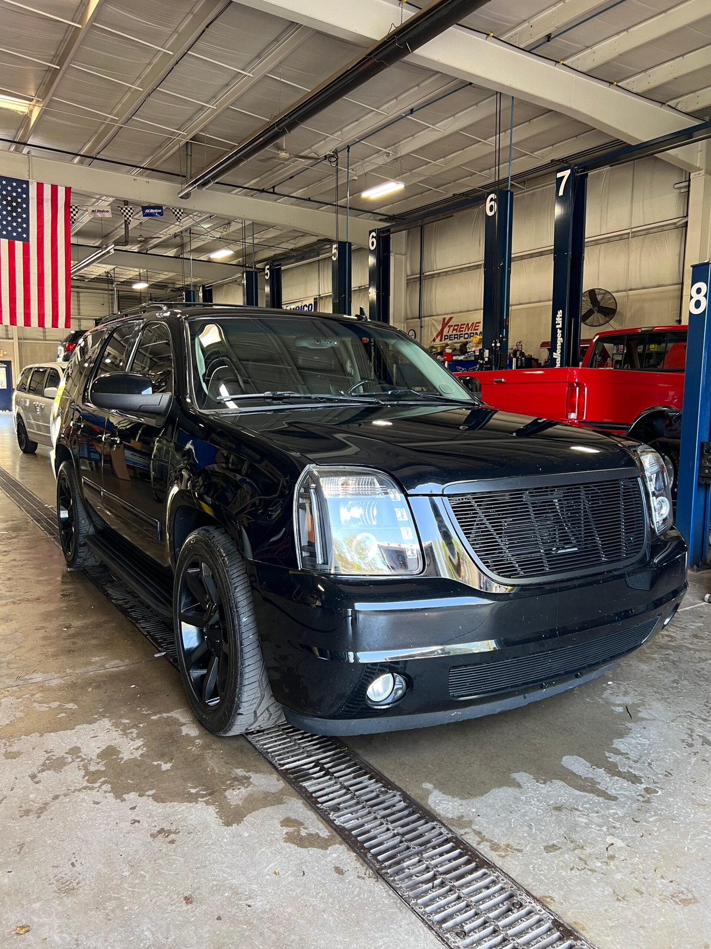Black GMC Yukon detailed and gleaming under shop lighting in Northeast Ohio