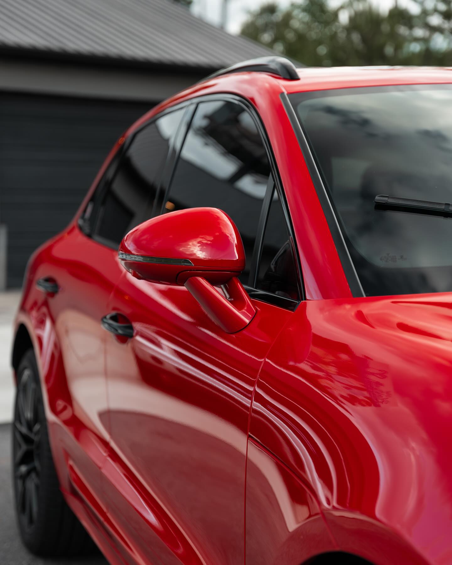 Gloss red Porsche Macan paint polished to a mirror finish after paint correction