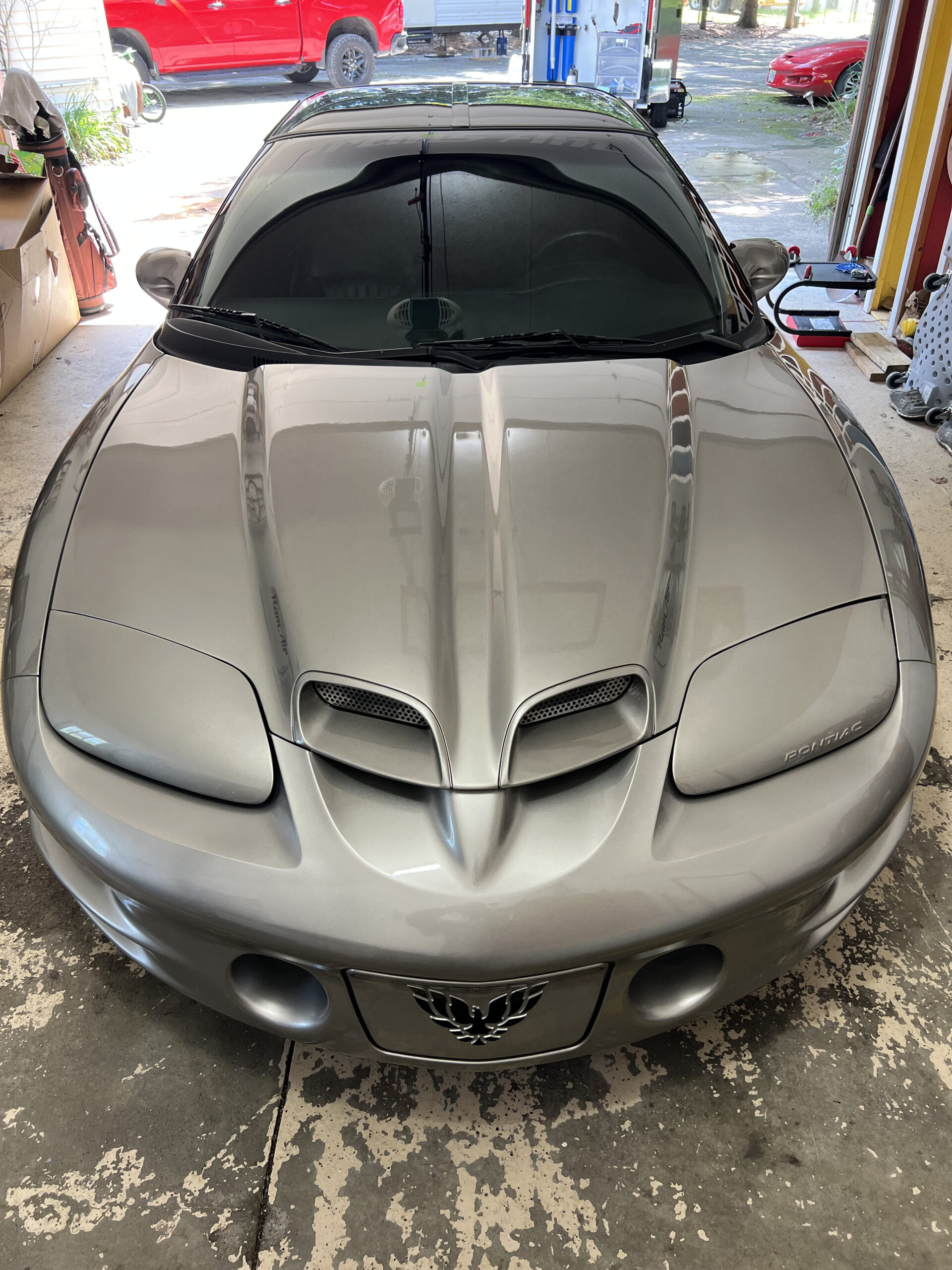 Ceramic coating giving a silver Pontiac Trans Am a deep glass-like gloss