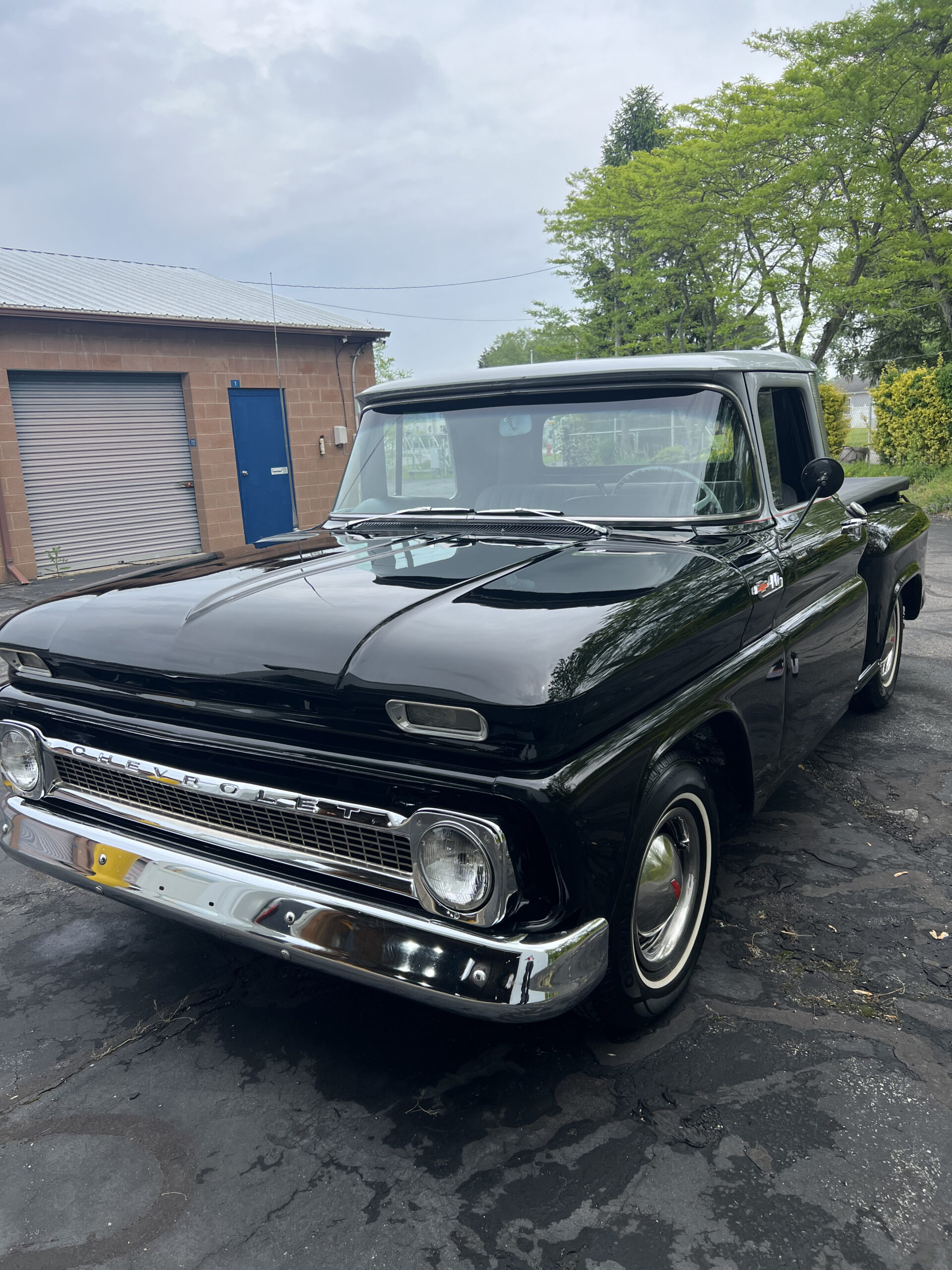 Classic black Chevrolet truck detailed at a customer's driveway